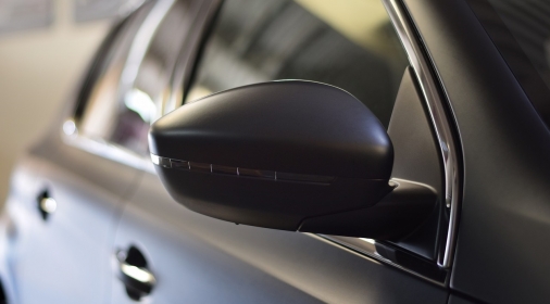 a grey car focused on the wing mirror