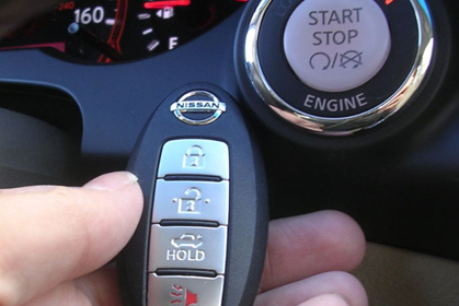 keyless car close up of the button to turn the car on with and the key to unlock the car