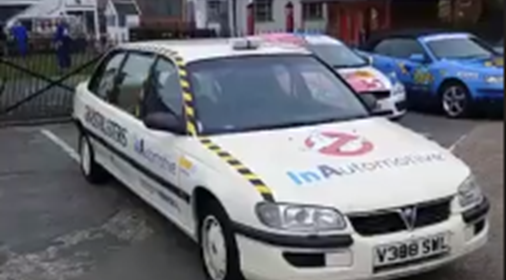 a white car decorated like ghostbusters