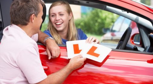 someone handing over their learner plates