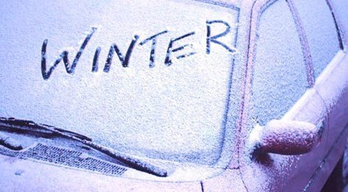 car with snow on it with winter written on the windscreen