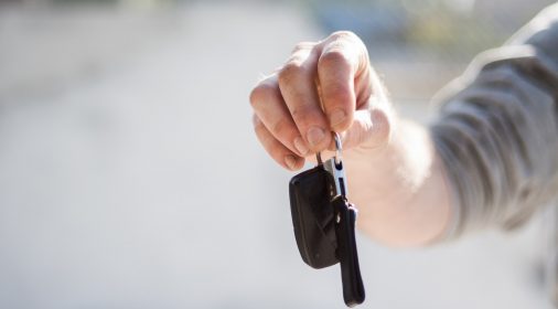 someone holding keys, background blurred