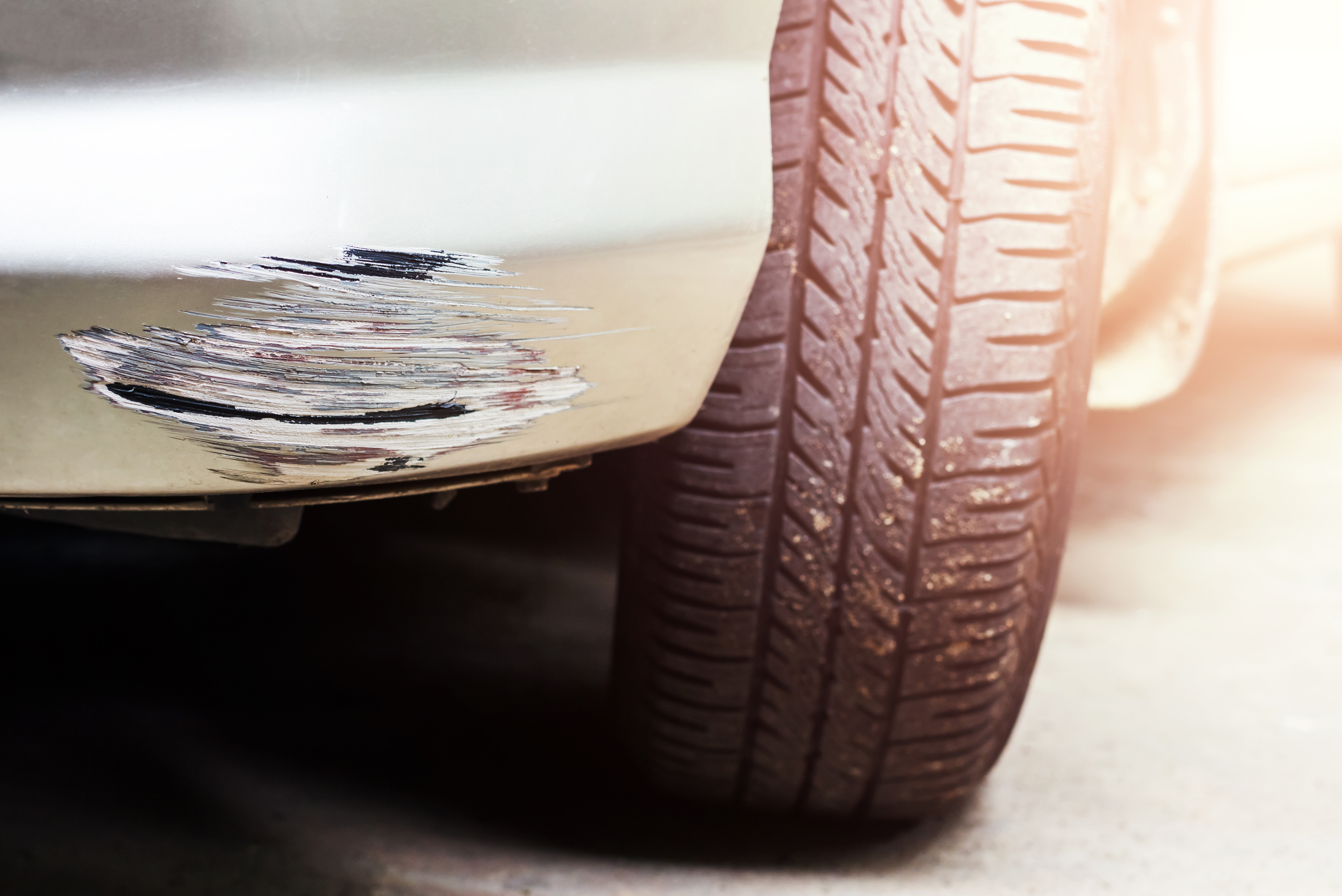 silver scratched car, bumper scuff