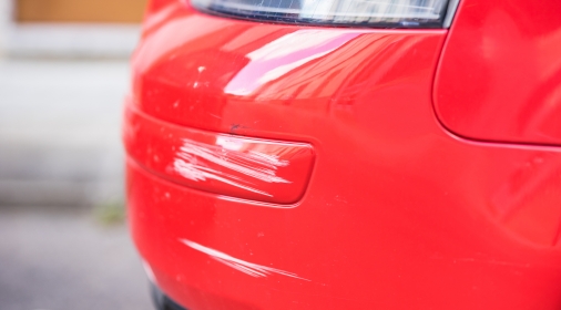 Red car bumper damage.