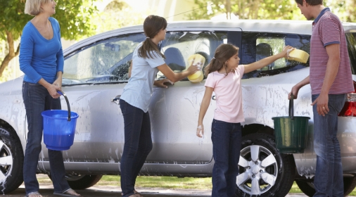 Family Washing Car Together With Buckets And Sponges.