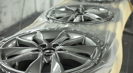 alloy wheels lined up to be repaired and refurbished painted silver