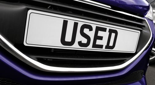 Used car number plate on purple car