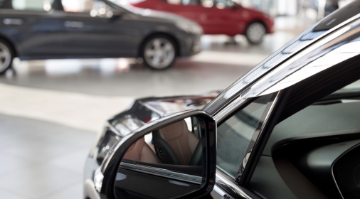 New cars at dealer showroom. Themed blur background with bokeh effect. Car auto dealership.