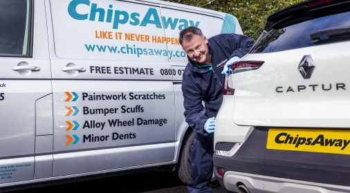 Mobile ChipsAway specialist looking at damage on customer car