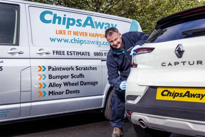 Mobile ChipsAway specialist looking at damage on customer car